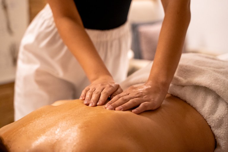 a surrogate getting a massage from a spa day package gift